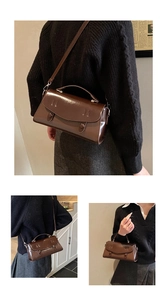 Detail of dark brown leather handbag showing double-button flap and crossbody strap