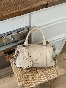 Vintage beige star-studded pillow handbag with heart charm and silver Aimelier logo
