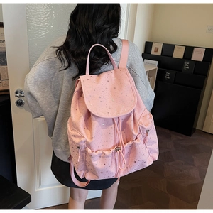 Pink casual backpack featuring silver star patterns and a drawstring flap closure design