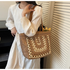 Detail of hand-woven straw tote with white crochet lace pattern and slim leather straps