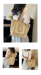 Detail of hand-woven beige straw tote bag with brown leather straps and floral accents