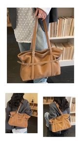 Macro shot of brown faux leather tote bag with stylish wrap-around strap and metal buckle