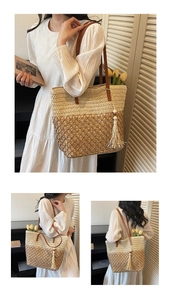 Detail of hollow woven straw tote bag featuring two-tone design and leather tassel charm