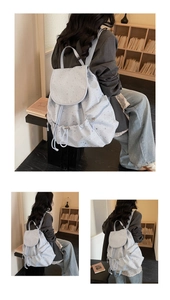 Close-up detail of light blue star sequin backpack with drawstring and side zip pockets