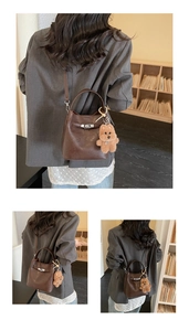 Detail of brown wax leather bucket bag with silver clasp and plush bear charm