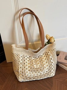 Straw woven tote bag with brown PU handles and hollow mesh texture for casual summer use