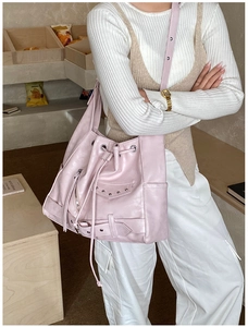 Detail of pink PU tote bag with silver studs and punk metal zippers on shoulder strap