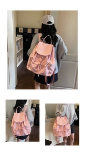 Detail of pink backpack with star prints showing drawstring closure and side pockets