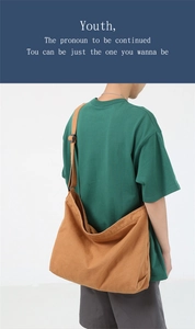 Rear view of model wearing a caramel canvas crossbody bag with adjustable strap