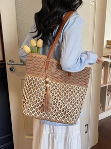 Large bohemian straw tote bag with dual-tone hollow weave and brown leather handles