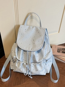 Light blue backpack with silver star patterns featuring drawstring and side zippers