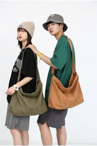 Detail of army green and caramel canvas crossbody bags with adjustable straps