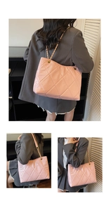 Detail of pink quilted tote bag with golden chain strap and rhombus stitching texture