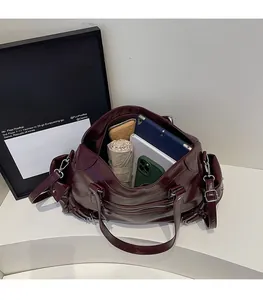Interior view of large capacity burgundy tote bag holding iPad, umbrella and wallet