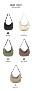 Detail view of canvas crescent bags in black, white, green, brown, and khaki colors
