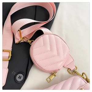 Detail of pink quilted round coin purse with gold zipper and stylish nylon strap