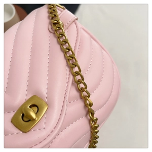 Detail of pink chevron quilted leather bag featuring a vintage gold-tone metal twist lock