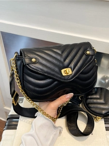 Black quilted V-stitch shoulder bag with gold hardware and dual chain straps