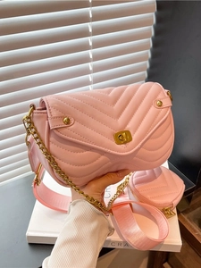 Pink quilted shoulder bag with chain strap and matching coin purse in a modern soft pink finish