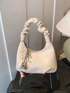 Beige floral embroidered cloud hobo bag with pleated handle and metal butterfly charm