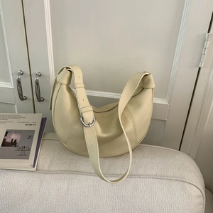 Detail shot of cream white leather hobo bag showing litchi texture and silver zipper