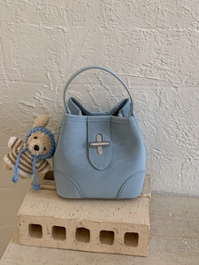 Sac seau élégant en cuir bleu clair avec fermoir argenté et bijou d'ours sur pierre