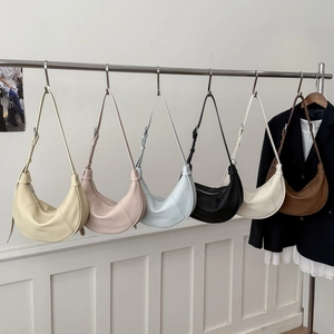 Detailed row of crescent leather shoulder bags in beige, pink, blue, black, and tan