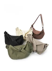Various colors of canvas half-moon crossbody bags including black, beige, and olive green