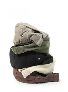 Detailed stack of five canvas beret hats in earthy colors with adjustable metal buckles