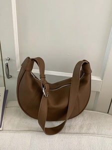 Minimalist brown leather crescent underarm bag with adjustable wide shoulder strap