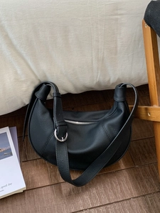Chic black crescent moon shoulder bag with metallic zipper and adjustable knotted strap