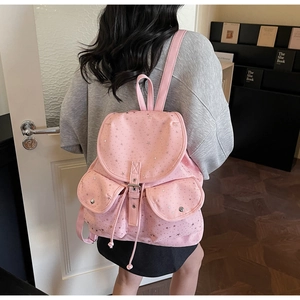 Pink star pattern backpack featuring dual front flap pockets and leather buckle closures