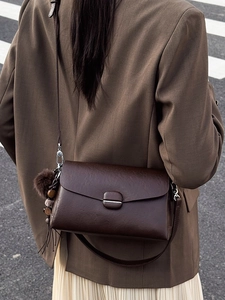 Classic dark brown vintage shoulder bag for women with decorative plush charm and flap