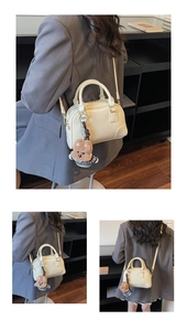 Detail view of beige Boston bag with premium leather texture and cute bear charm accessory
