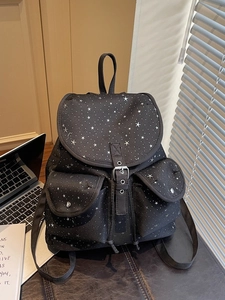 Retro student backpack with white star print and metallic buckle in a casual lifestyle setting