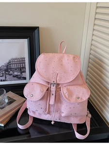 Pink casual school backpack with silver star patterns in a stylish minimalist interior