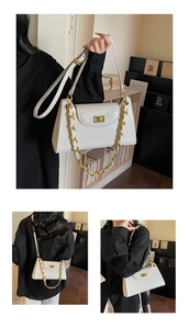 Detail of white patent leather shoulder bag with gold square lock and chain strap