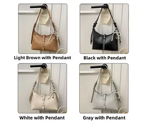 Macro detail of dumpling bags in four colors with pearl bow charms and rivet straps