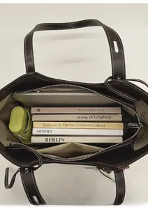 Deep brown tote bag interior showing capacity for 14-inch laptop and books