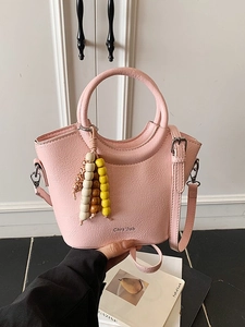 Pink lychee texture bucket bag with round handle and colorful bead charm for women