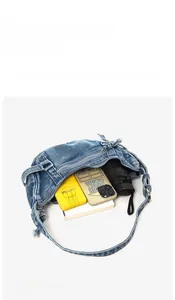 Aperçu de la capacité du sac à bandoulière en denim bleu délavé avec objets internes