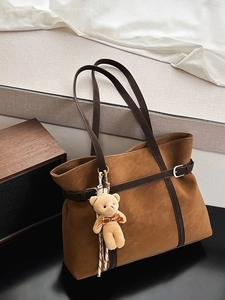 Vintage brown large capacity tote bag with cute teddy bear charm on textured fabric