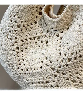 Detailed macro shot of hollow crochet knit texture and lining on woven beach bag