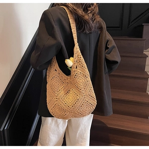 Detailed crochet hobo bag with hollow diamond pattern and wide shoulder strap