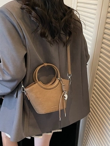 Sac seau marron en cuir avec poignées circulaires et bandoulière amovible