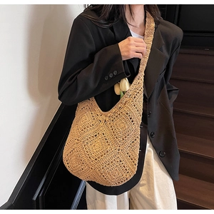 Detailed close-up of woven straw tote bag with elegant hollow diamond pattern