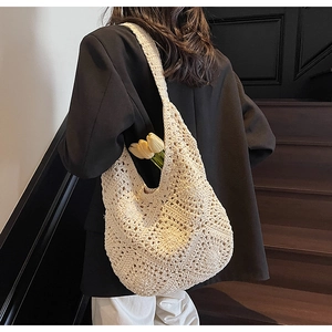 Chic beige crochet shoulder bag shown on model for size perspective and texture