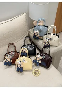 Close-up of stylish faux leather handbags in multiple colors with bear charms