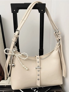 Minimalist beige half-moon shoulder bag with double straps and pearl bow charm detail