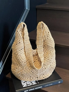 Beige floral crochet shoulder bag with spacious design for vacation and beach styling